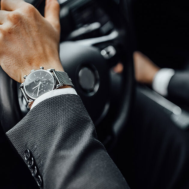 man gripping steering wheel